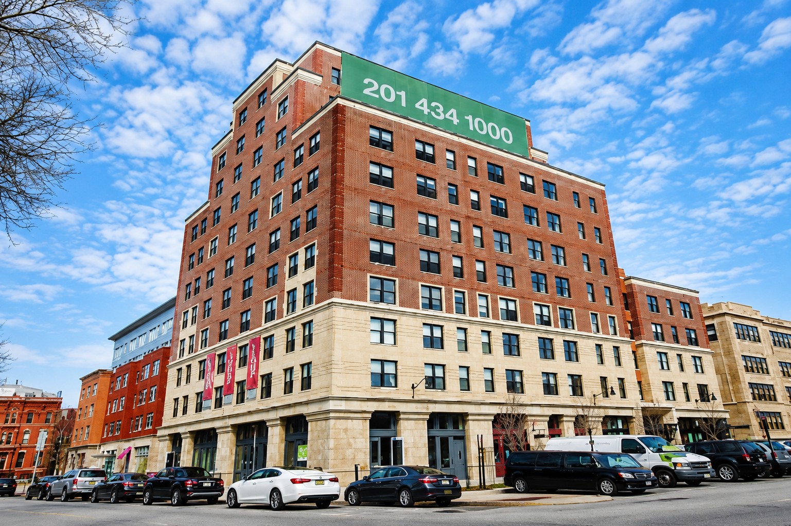 Modern mixed-use brick building with retail storefronts and residential apartments.